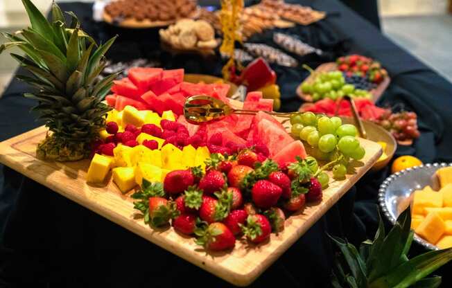 a tray of fruit on a table with a pineapple