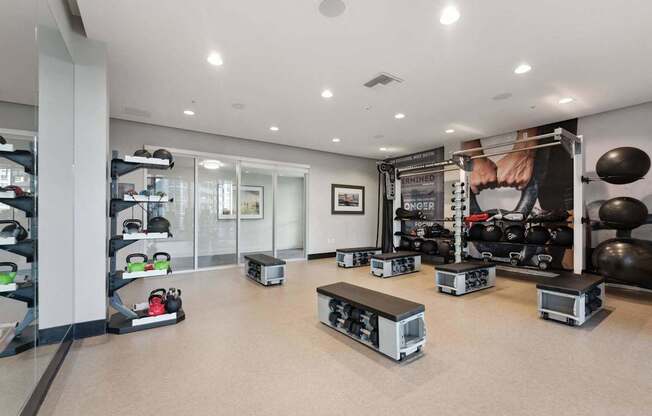 A gym with a variety of equipment including weights and machines.