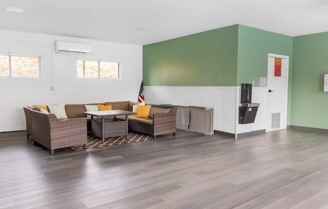 A living room with a couch, chairs, and a coffee table.