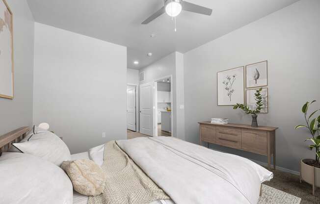 a bedroom with a large bed and a ceiling fan