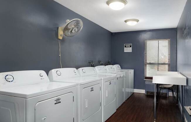 A laundry room with washers and dryers.