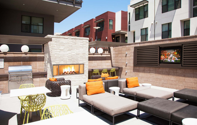 a patio with couches and chairs and a fireplace