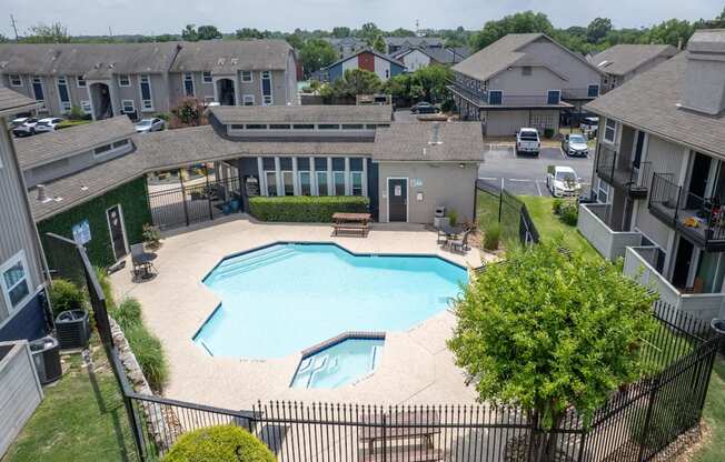 A swimming pool in a residential area surrounded by houses.
