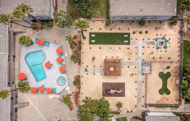 A playground with a blue slide and orange chairs.