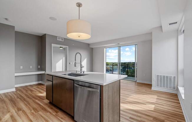 A modern kitchen with a large island and stainless steel appliances.