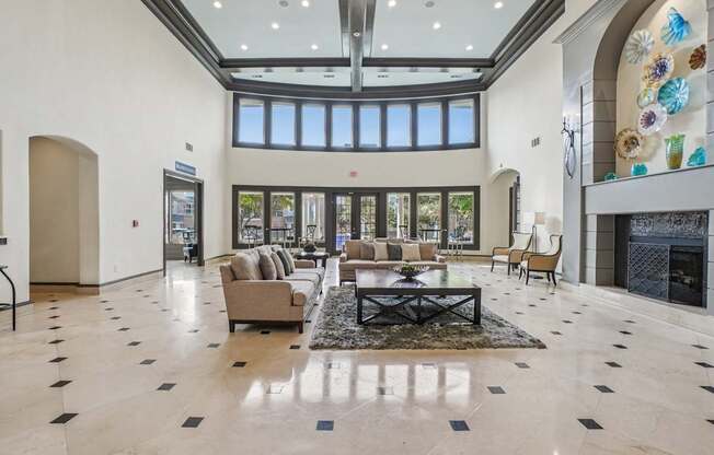 A spacious living room with a fireplace and a large window.