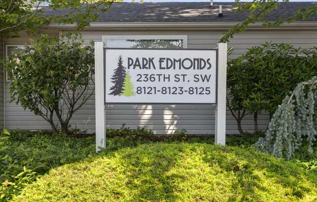 Property Sign surrounded by Green Grass and Trees at Park Edmonds Apartment Homes, Washington