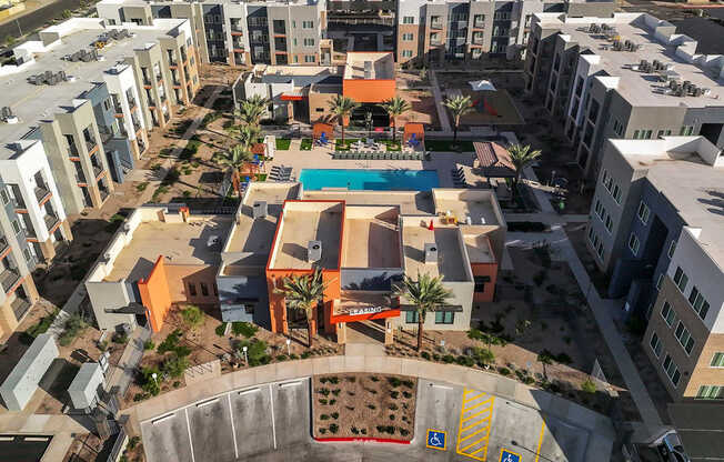 A view of a courtyard surrounded by buildings with a pool in the middle.