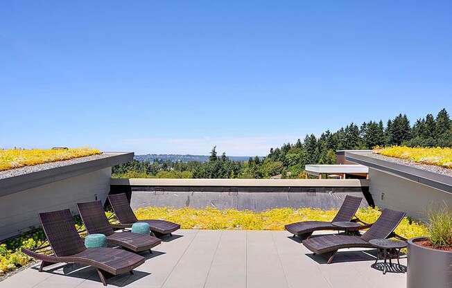 A patio with chairs and a roof garden. at Kirkland Crossing Apartments, Washington, 98033