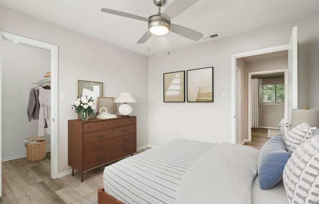 a bedroom with a large bed and a ceiling fan