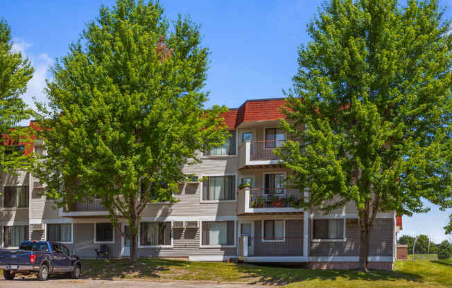 a truck parked in front of an apartment building