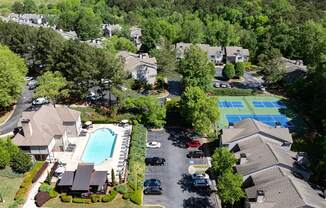 A bird's eye view of Wesley Place apartments, a swimming pool, and a tennis court.