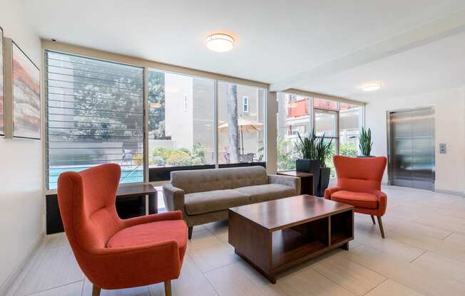 Sherman Oaks Apartments - Krystal Terrace Apartments Lobby with Table, Cozy Seating, and Modern Decor