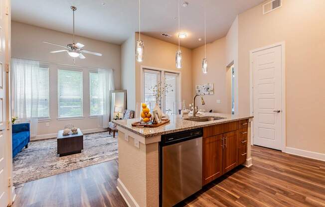 A kitchen with a large island and a fan.