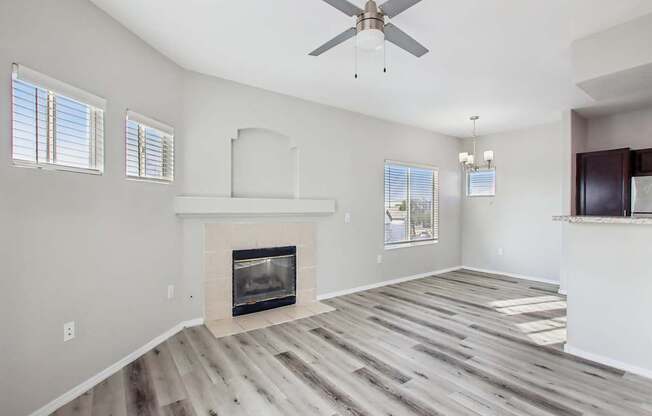 A room with a fireplace and a ceiling fan.