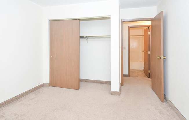 Bedroom with Sliding Closet Doors and Across from Bathroom