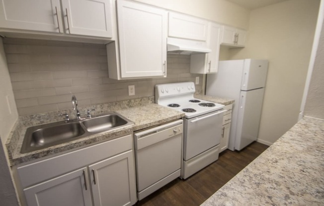 This is a photo of the kitchen of an upgraded 554 square foot 1 bedroom apartment at The Biltmore Apartments in Dallas, TX.