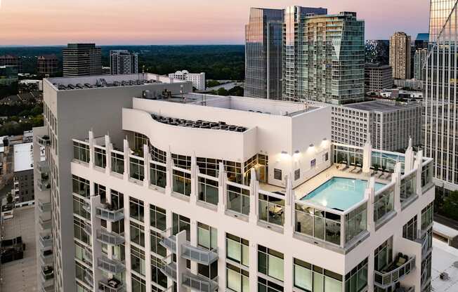 an aerial view of a skyscraper with a pool on the roof of a building