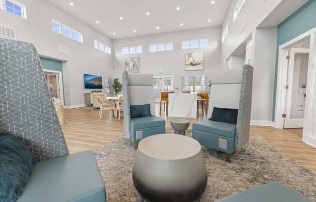 a living room with blue chairs and a coffee table