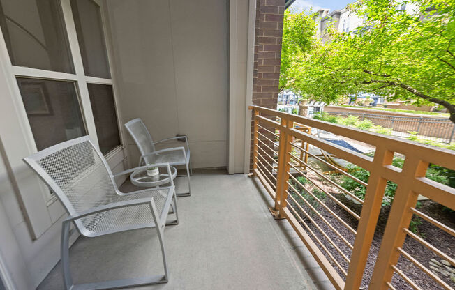 a balcony with chairs and a table on a balcony