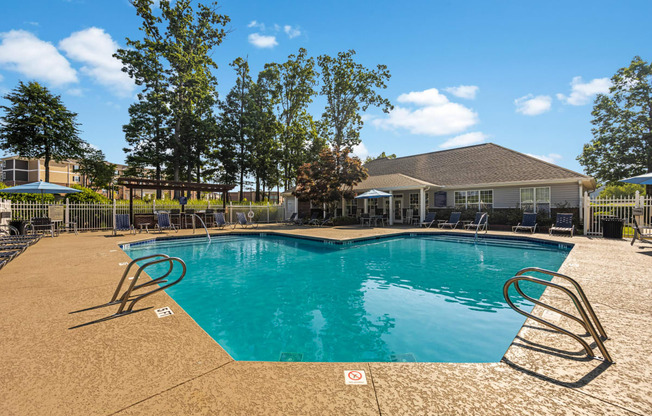 a swimming pool with a house in the background