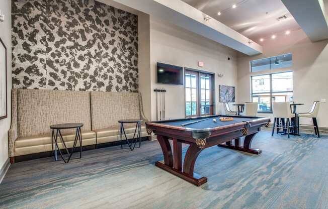 a games room with a pool table and a tv