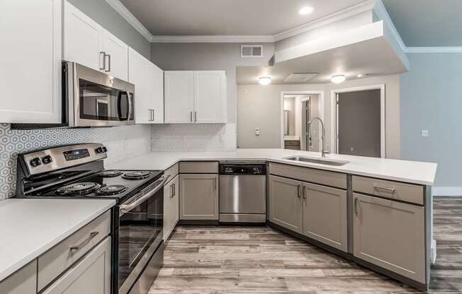 A modern kitchen with a stove, microwave, and dishwasher.