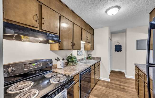 a kitchen with stainless steel appliances and wooden cabinets