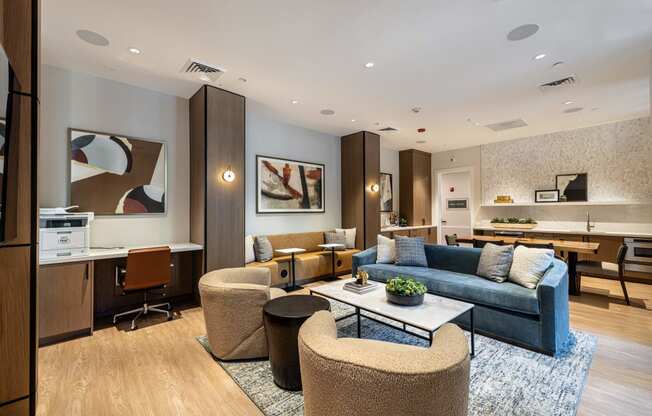 a living room with a blue couch and chairs and a table