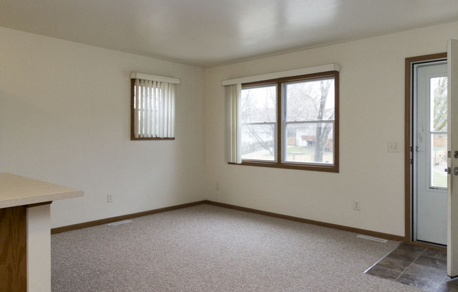 The living area in this Meredith Homes 3 bedroom apartment features great windows and a screeen door.