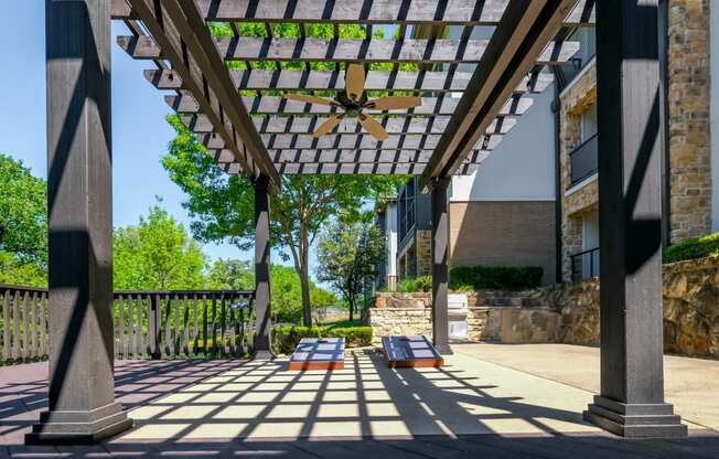 outdoor pergola social area with cornhole at Berkshire Medical District apartments