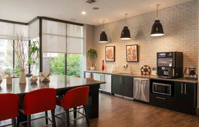 A modern kitchen with a dining table and chairs at Regatta Sloans Lake Apartments, Denver