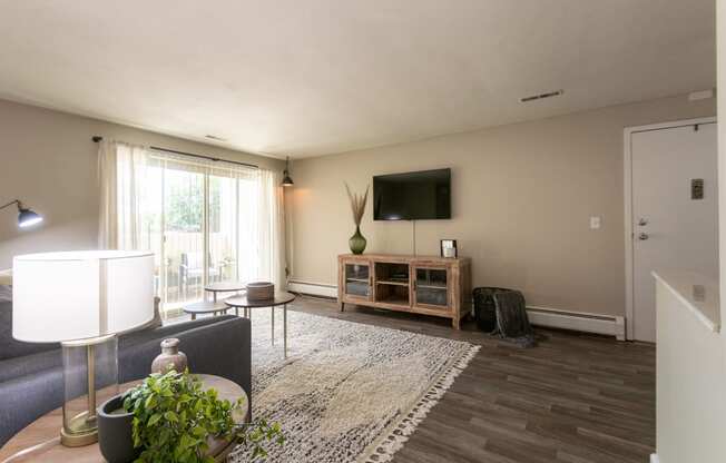 This is picture of the living room and patio in the 823 square foot 2 bedroom apartment at Aspen Village Apartments in the Westwood neighborhood of Cincinnati, OH.