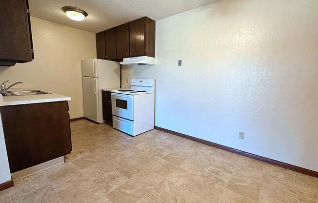 a kitchen with a sink and a refrigerator