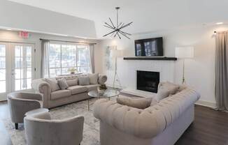 A living room with a fireplace and a large couch.