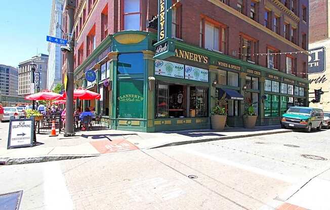 a city street with a green building on the corner at East 4th Street, Ohio, 44115