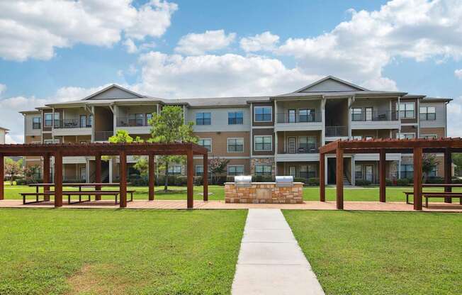 A large apartment complex with a walkway leading to the front door.