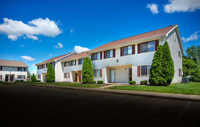 Building exterior with landscaping at indian woods apartments