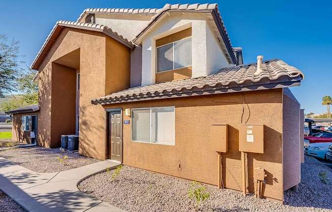 A house with a brown and beige exterior and a tiled roof at Sterling Point Apartment Homes, Phoenix