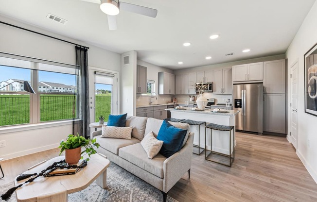 a living room and kitchen with a couch and a table