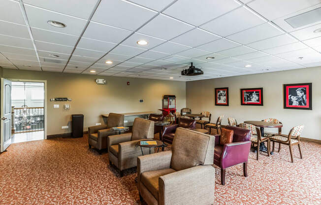 a large dining room with tables and chairs and a large wall with geometric patterns on