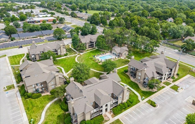 an aerial view of houses in a neighborhood with a swimming pool