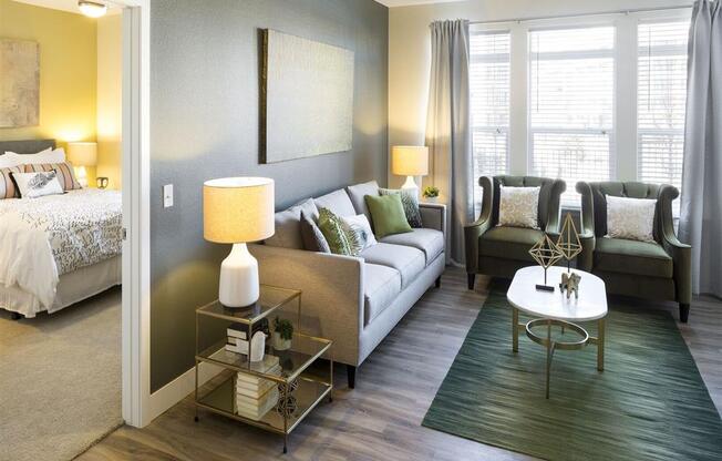 a living room filled with furniture and a large window