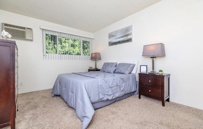 a bedroom with a bed and desk in a room