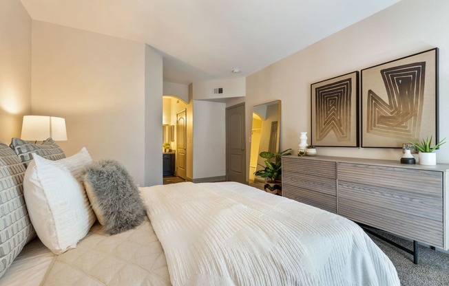 a bedroom with a large bed and a dresser at Mirasol Apartments, Las Vegas, Nevada