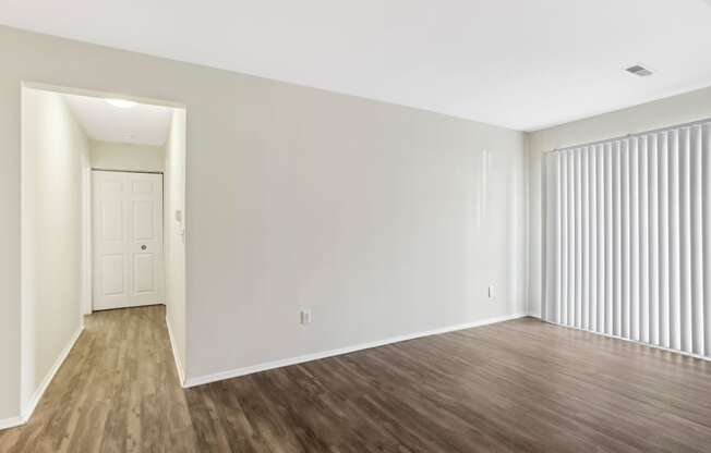 A room with wooden floors and white walls.