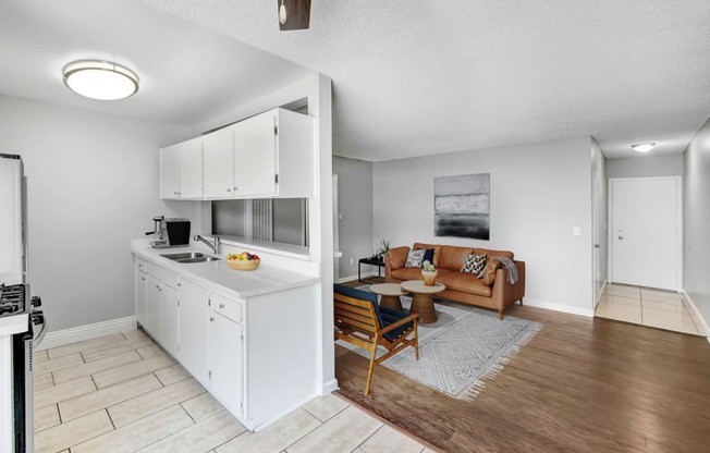 a living room with a kitchen and a couch