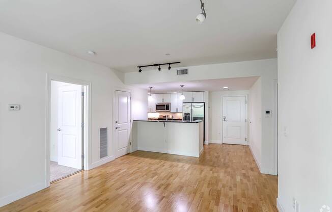 A kitchen with white cabinets and a wooden floors at 7 Cameron Apartments, Cambridge, Massachusetts