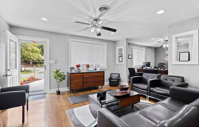 A living room with a ceiling fan and a large couch.