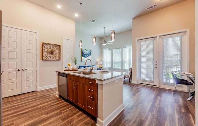 A kitchen with wooden floors and a white island.